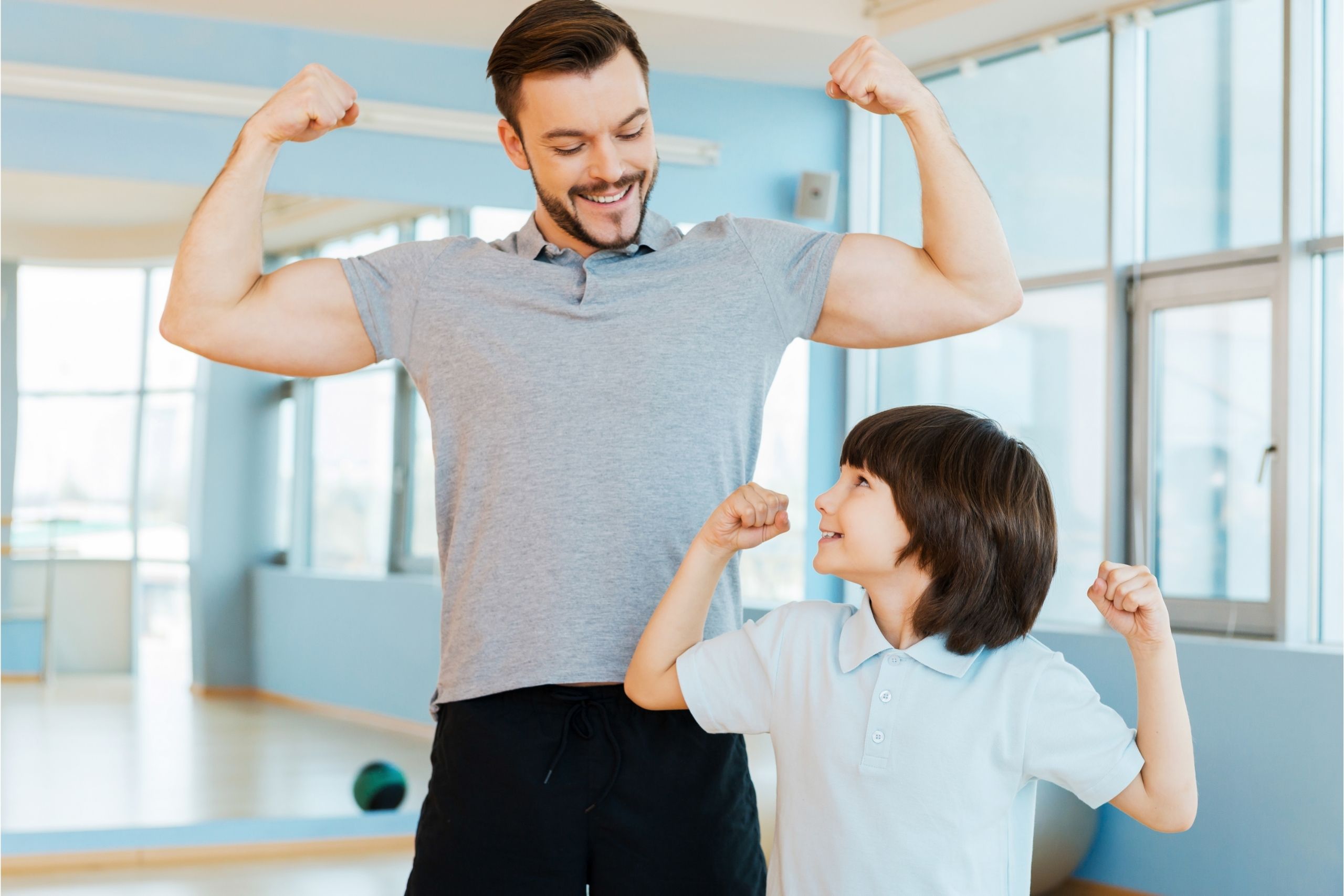 dad and son flexing