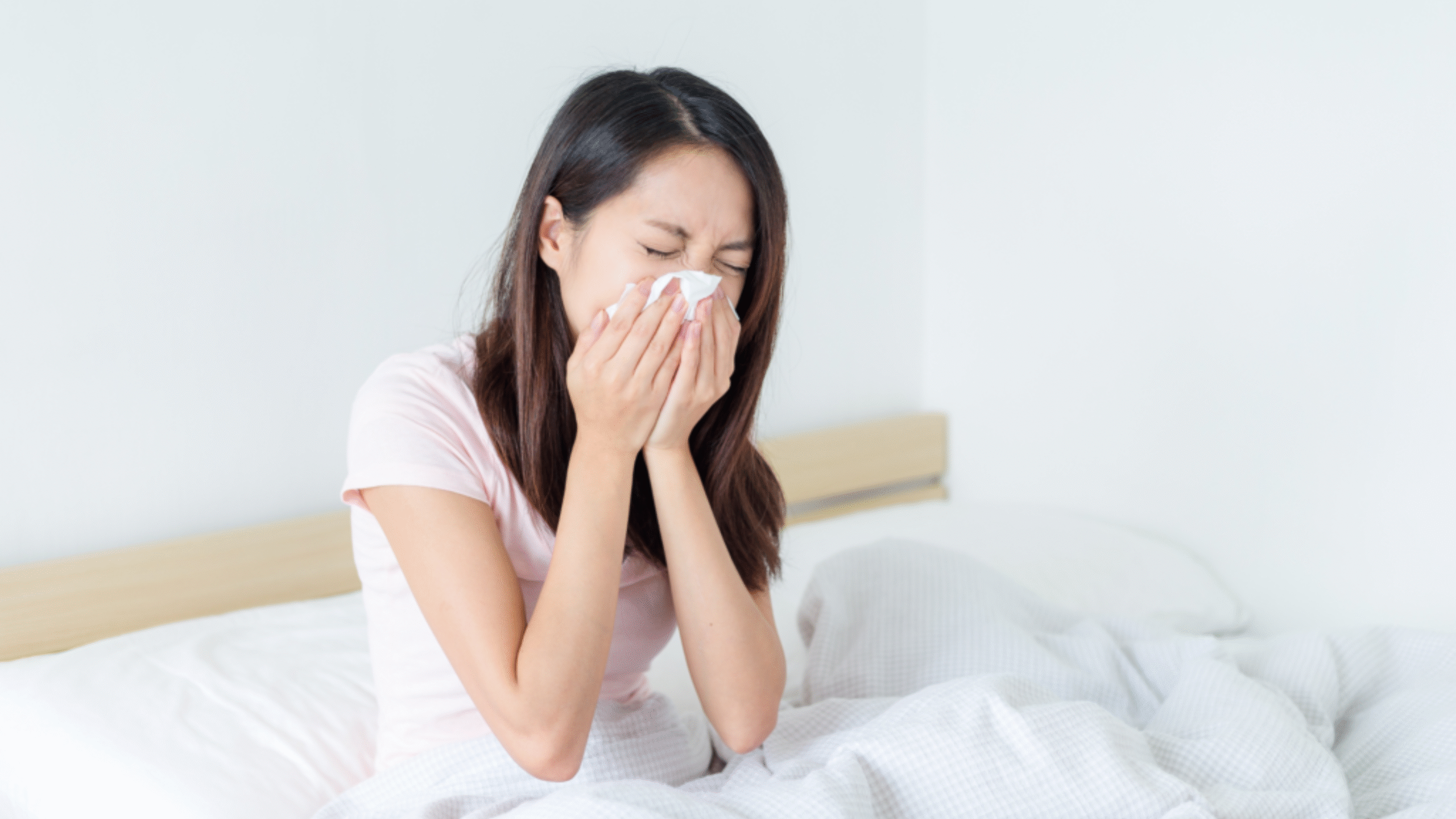 woman sneezing in napkin