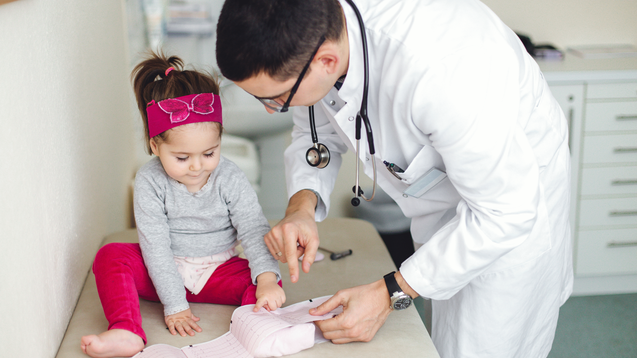 Doctor with young patient checking heart