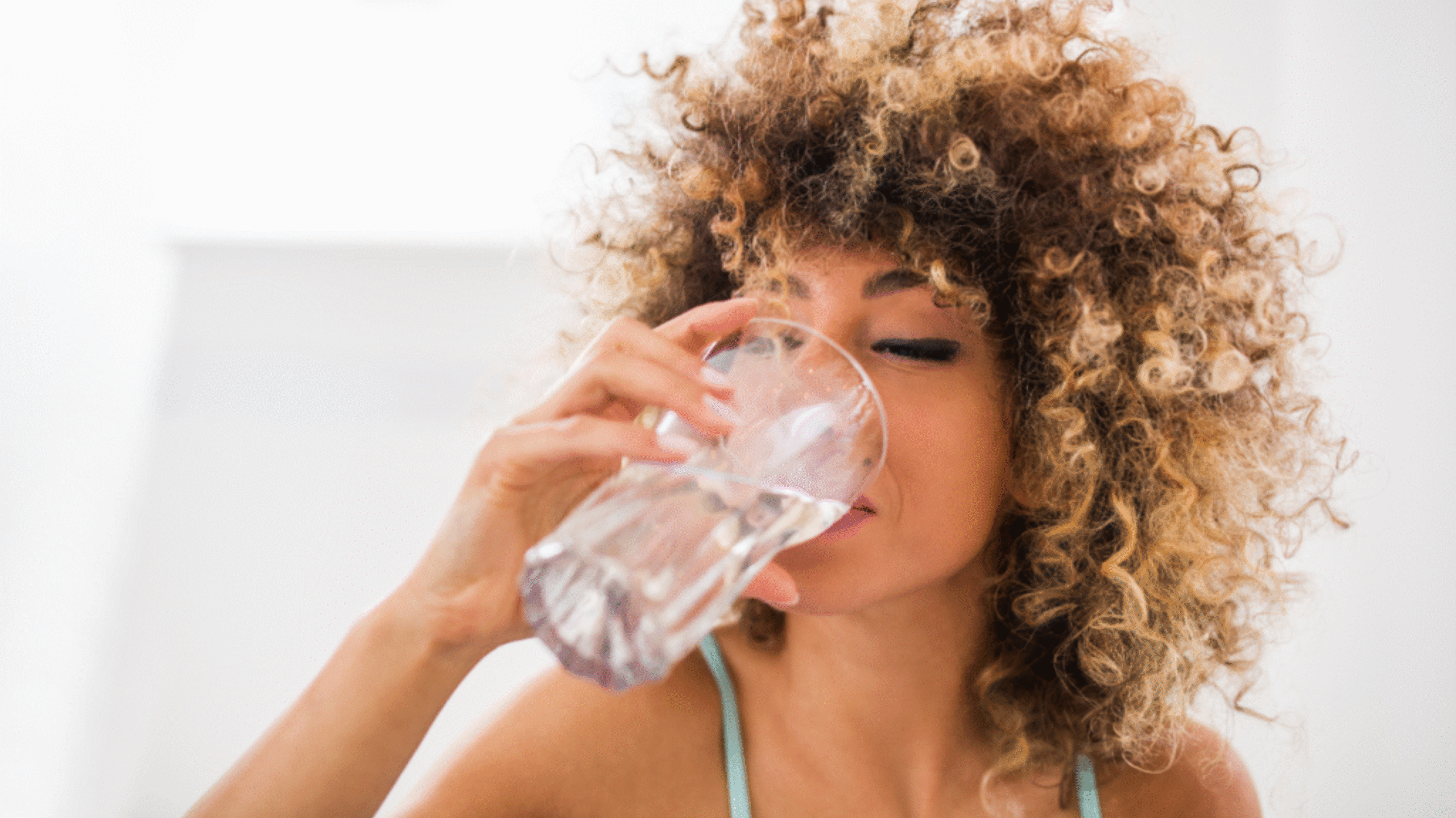 woman drinking full glass of water