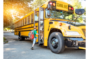 child getting on the school bus