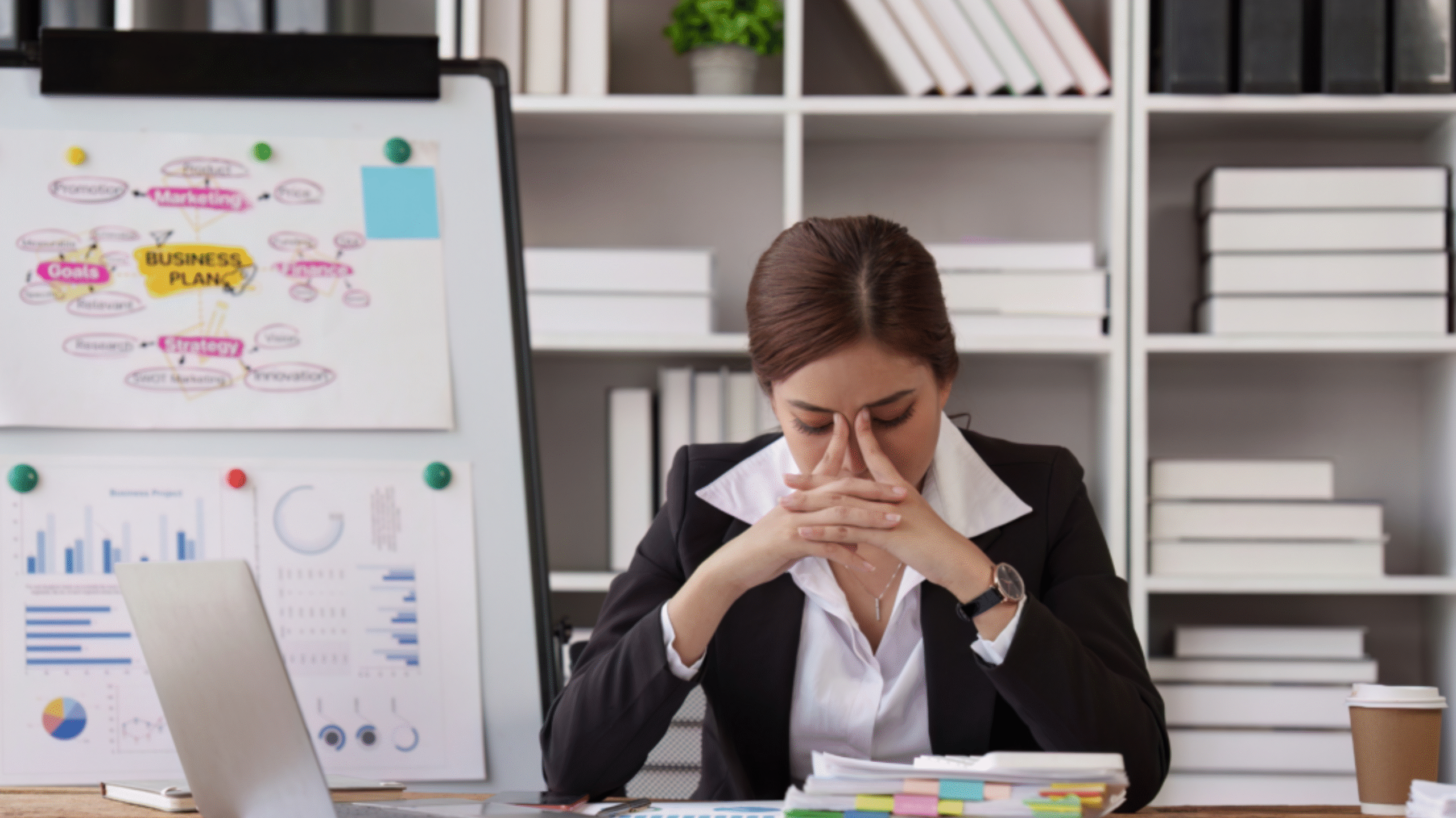 lady with hands on face leaning on desk