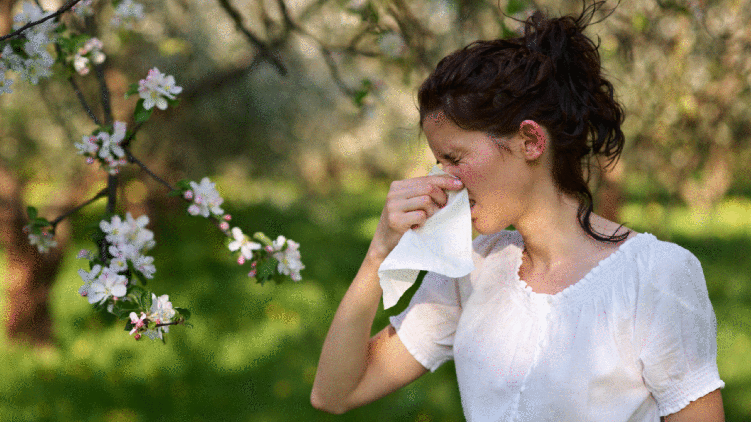 lady blowing nose outside