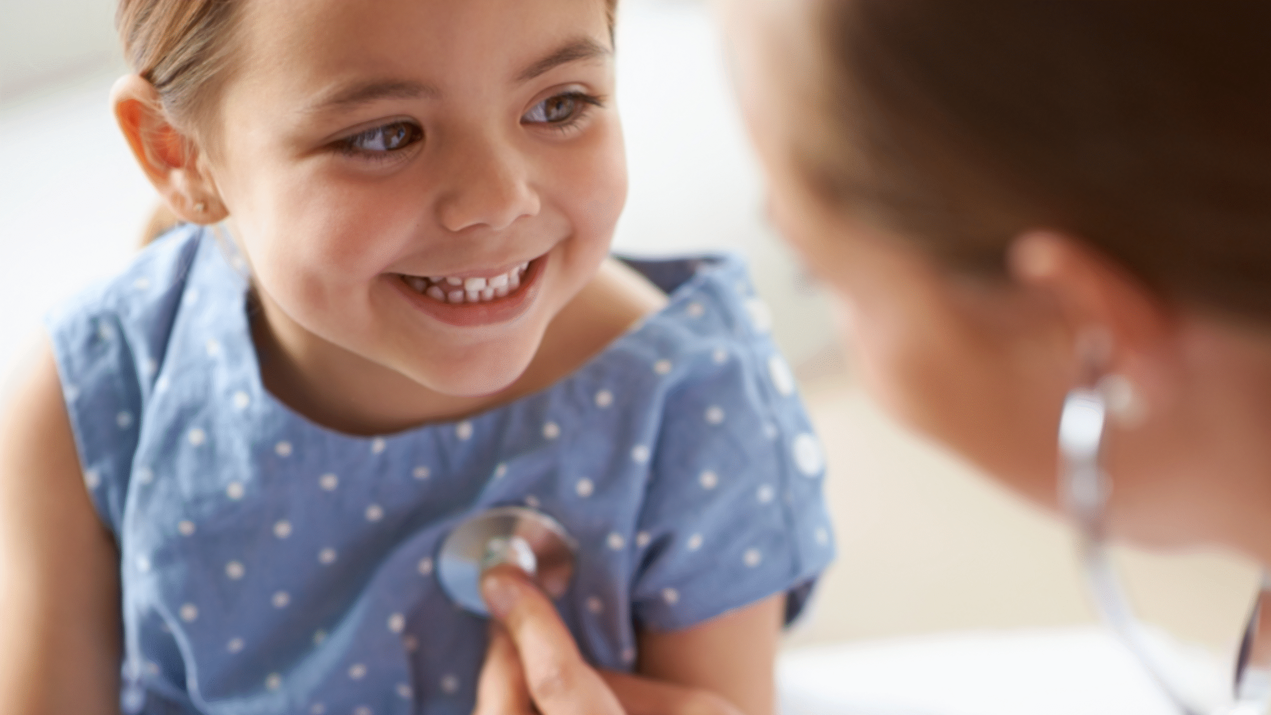 physician listening to child's heart
