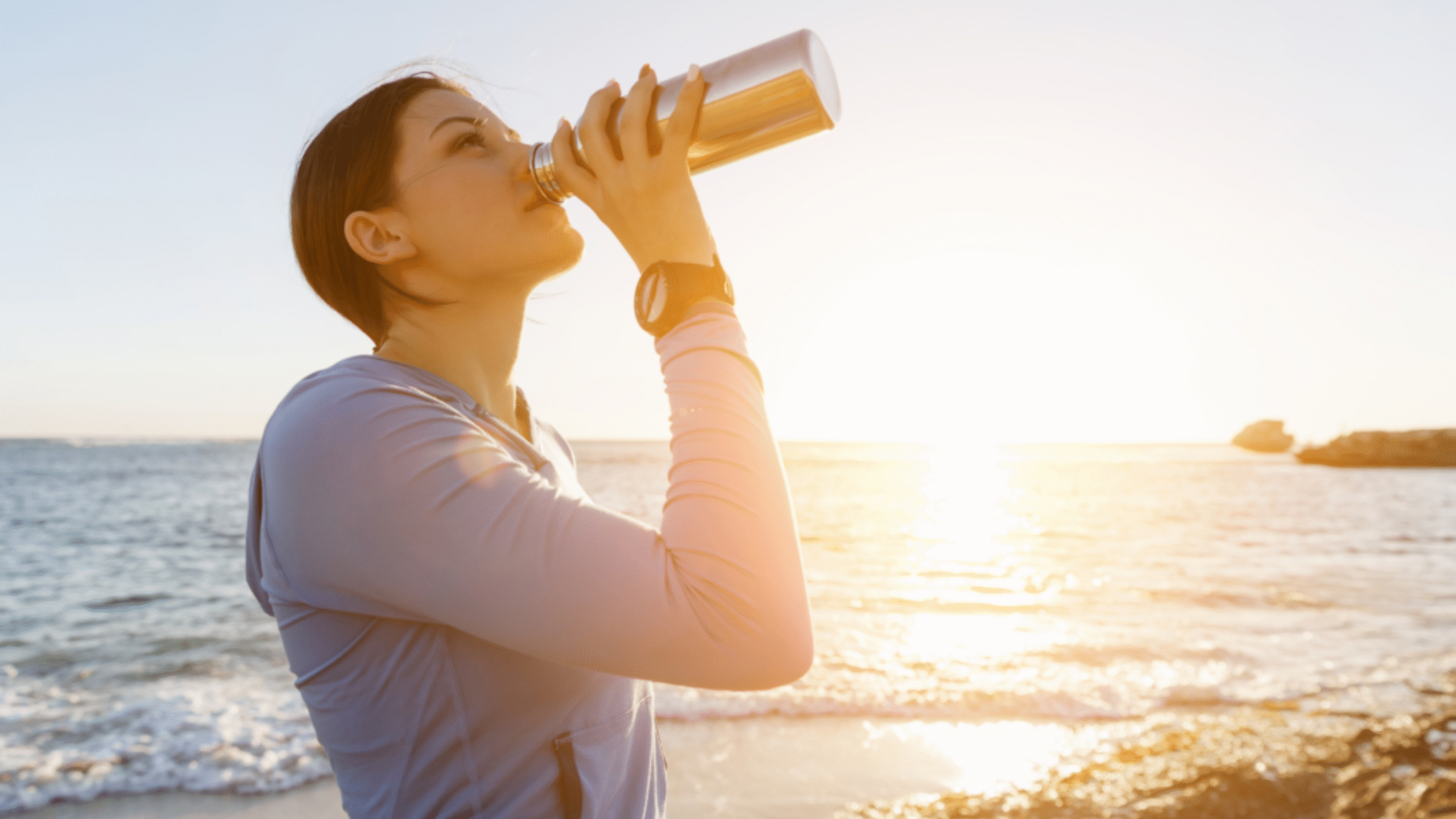 woman drinking water to stay hydrated