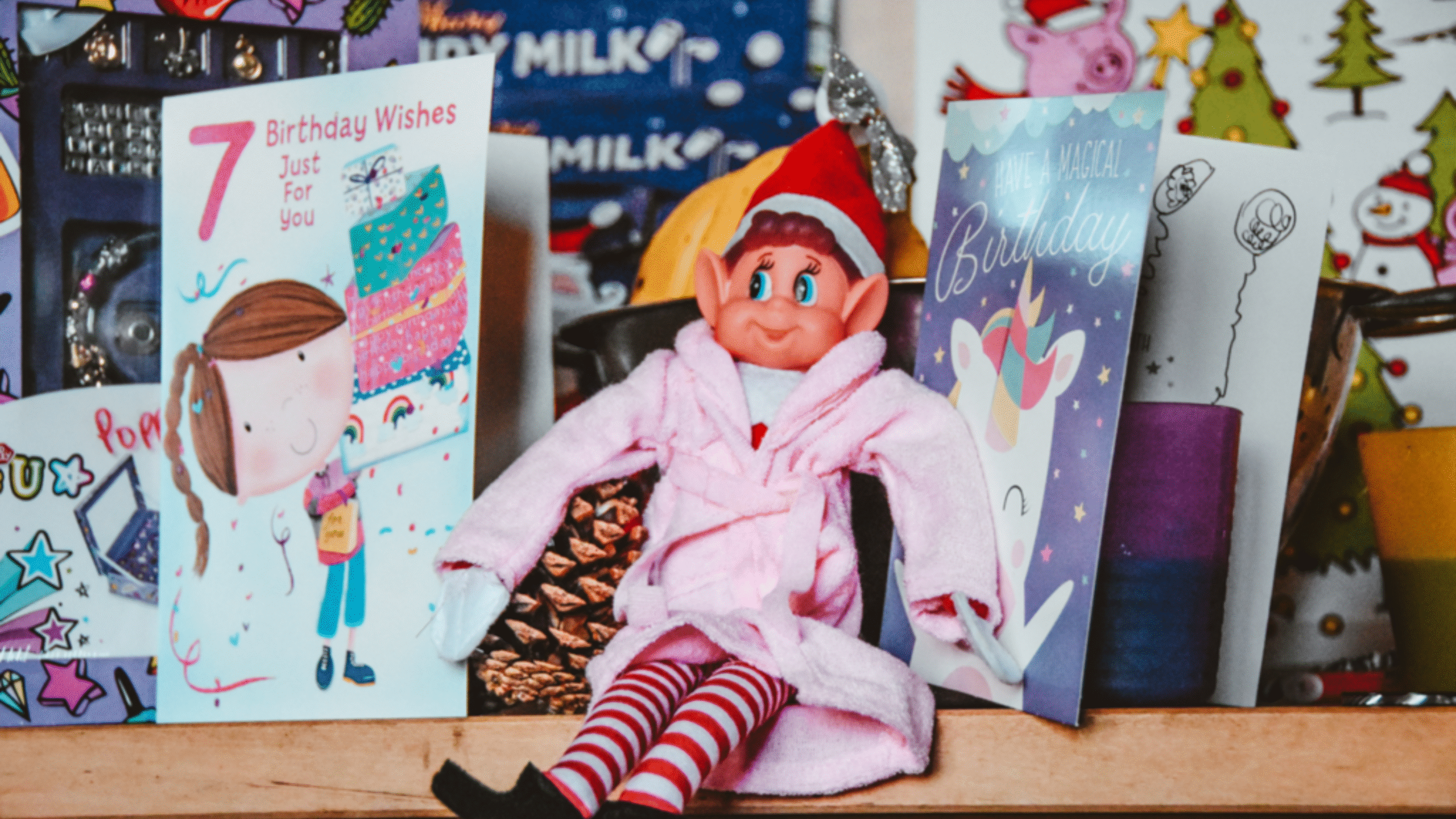 Elf on the Shelf doll in a robe on fire place