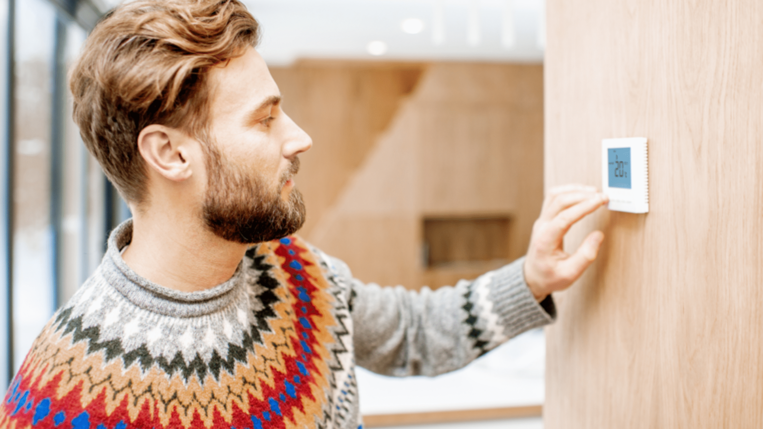 man fixing his thermostat