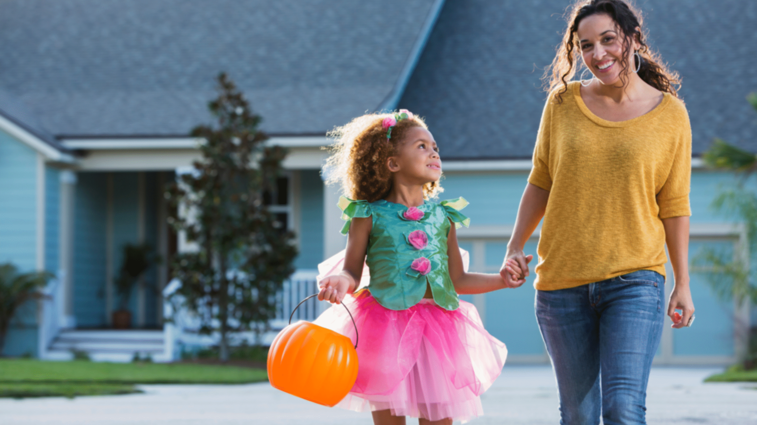 mother takes her child out to trick or treat