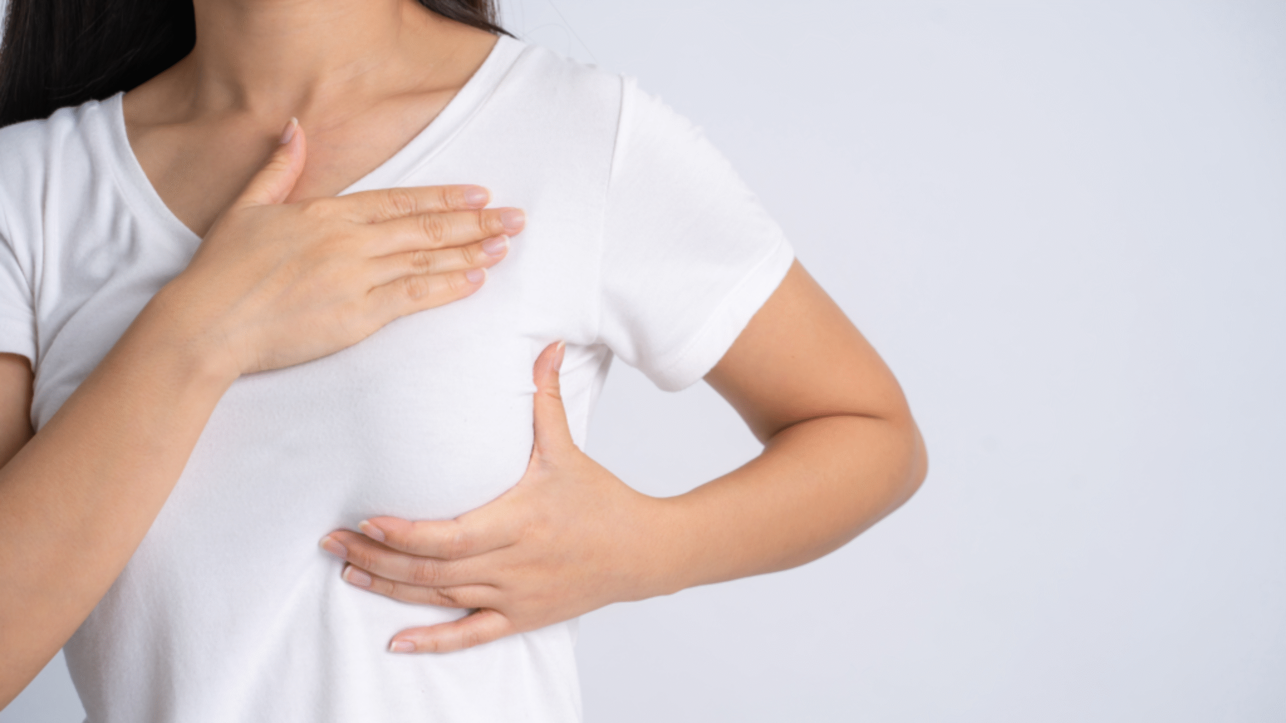 Woman performs self-breast exam