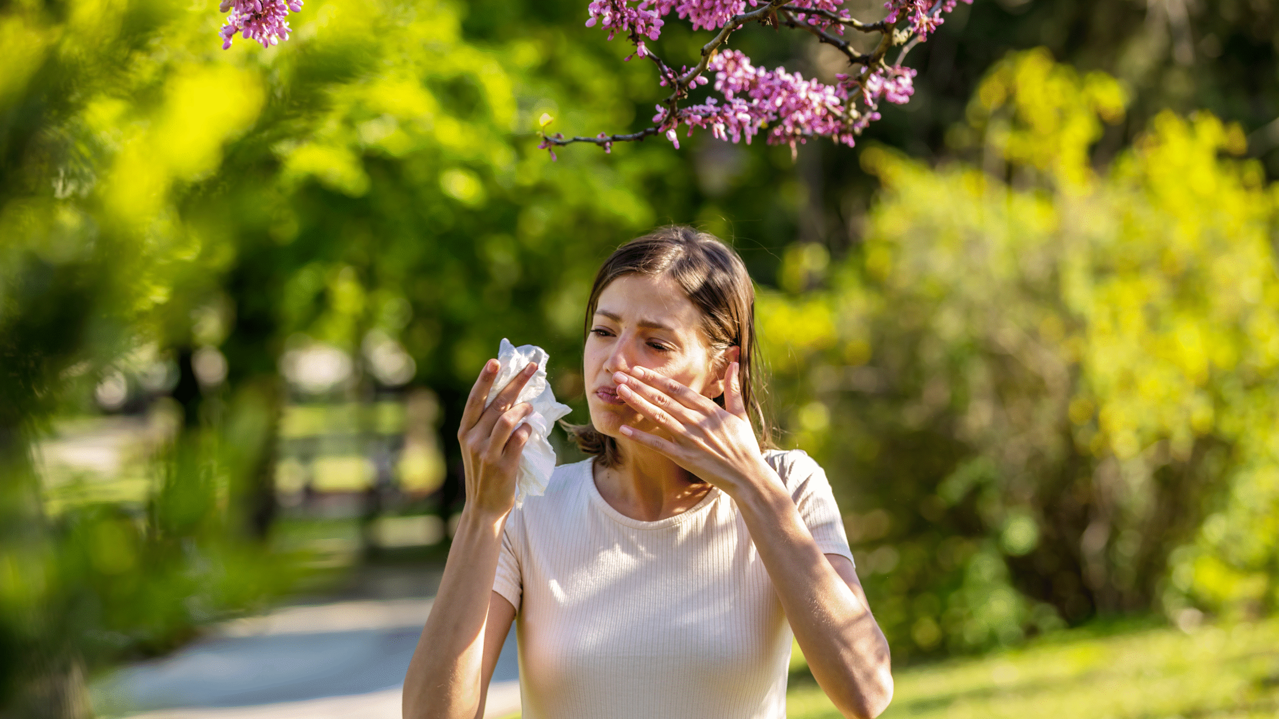 woman suffering from runny nose and watery eyes due to allergies