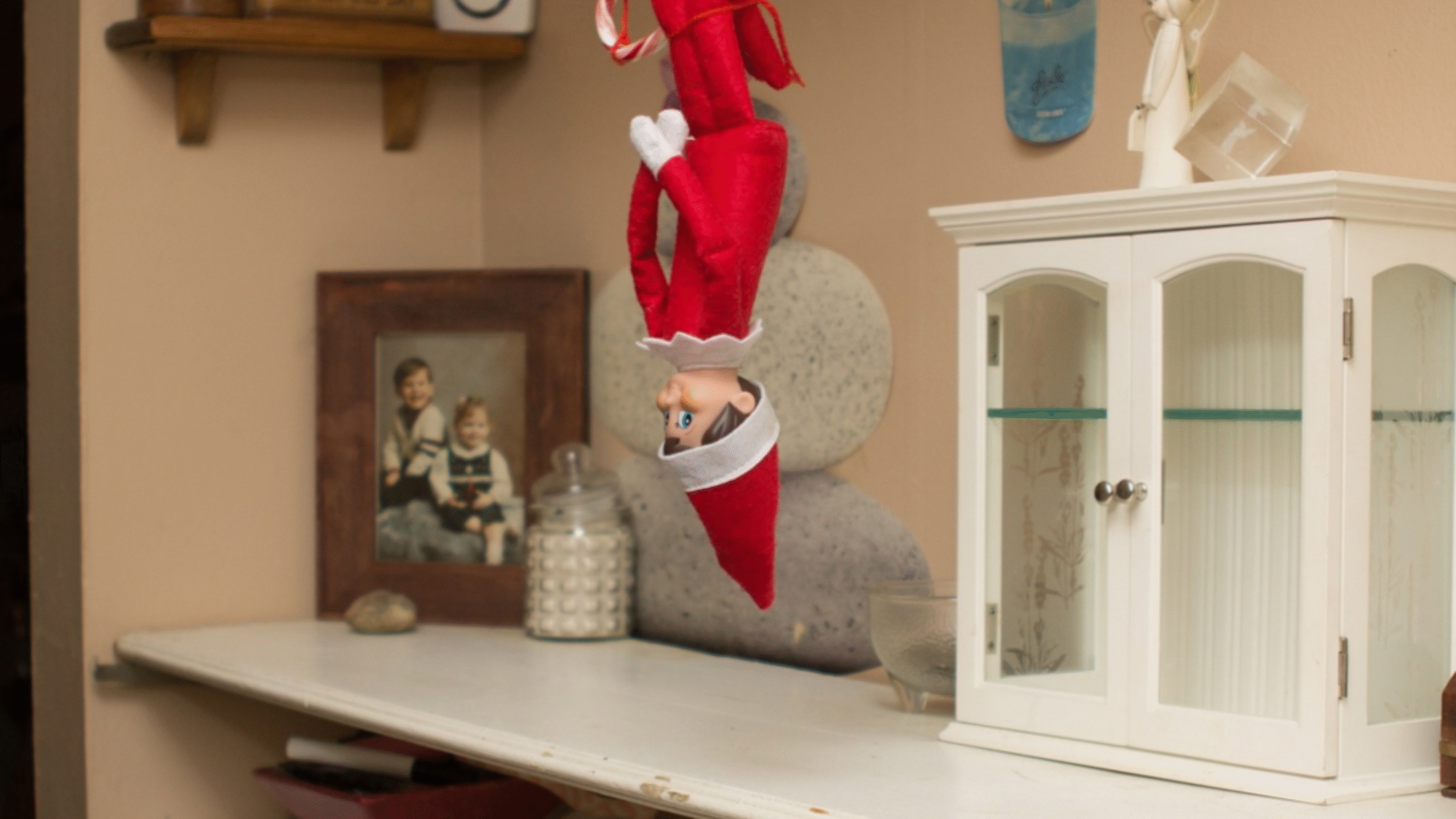 Elf on the Shelf hanging upside down