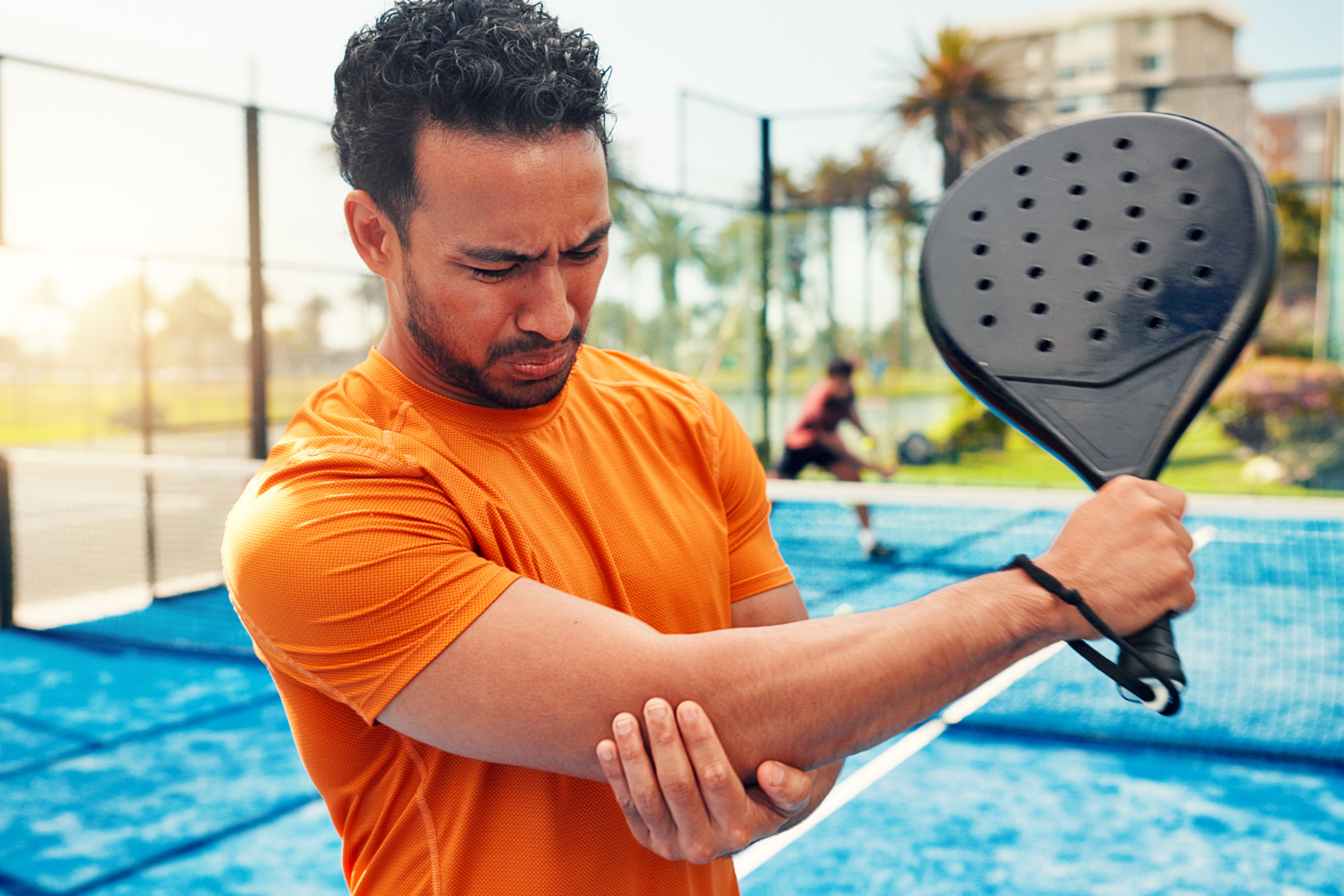 man with hurt arm playing sports